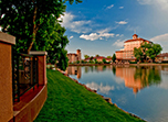 a body of water with a body of water and a building in the distance