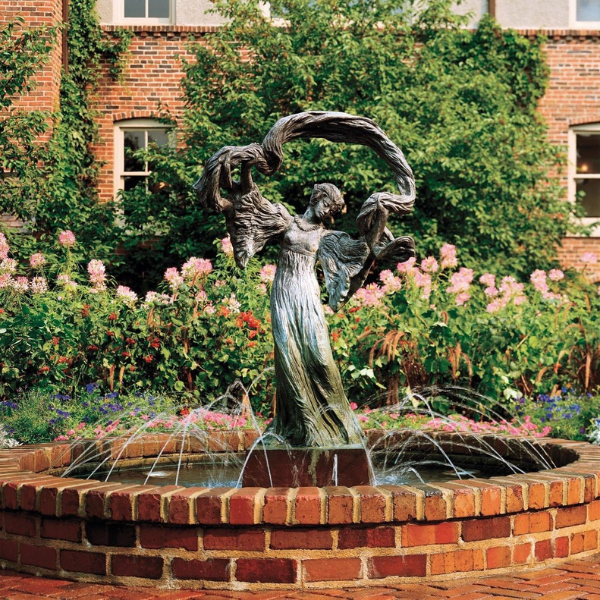 a statue of a woman in a garden