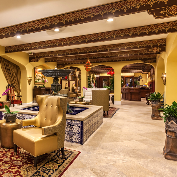 a room with a fountain and chairs