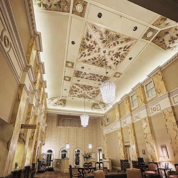 a room with a chandelier and chairs