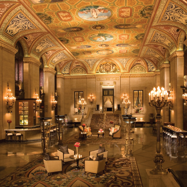 a large ornate room with chandeliers and chairs with The Palmer House Hilton in the background