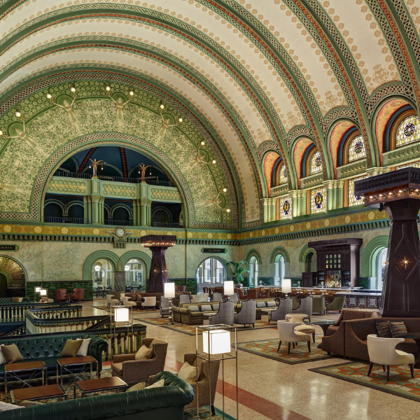 a large room with many chairs and tables with Union Station in the background