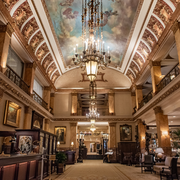 a large ornate building with a chandelier and a painted ceiling