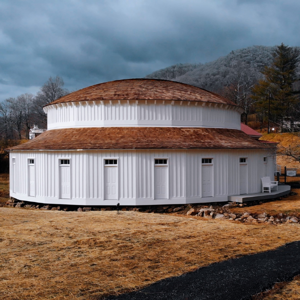 a round white building with a brown roof