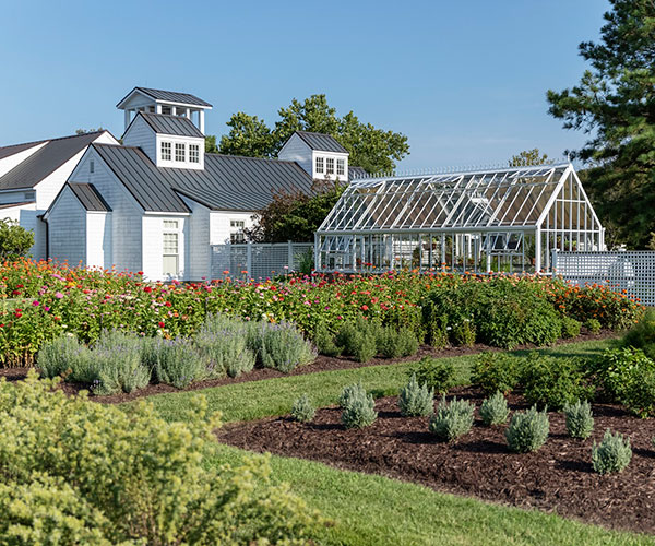 a greenhouse in front of a white house