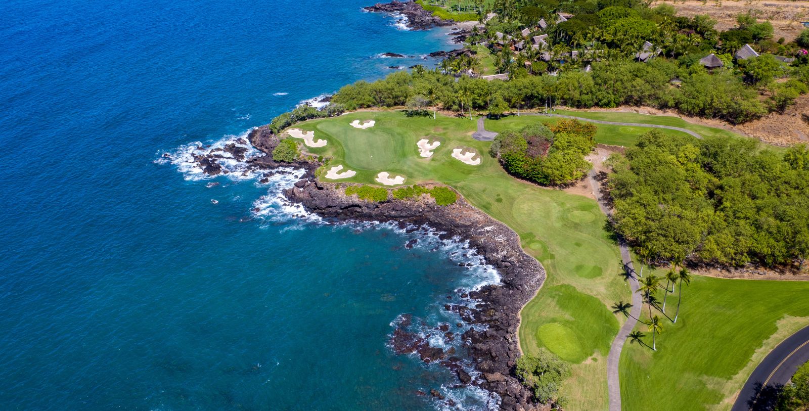 a golf course with a body of water