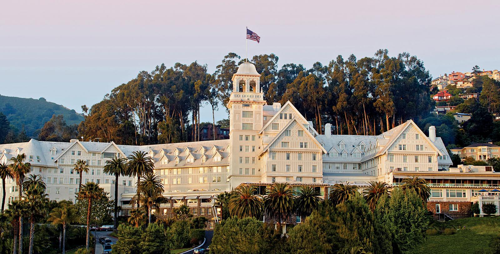 a large white building with a flag on top 12