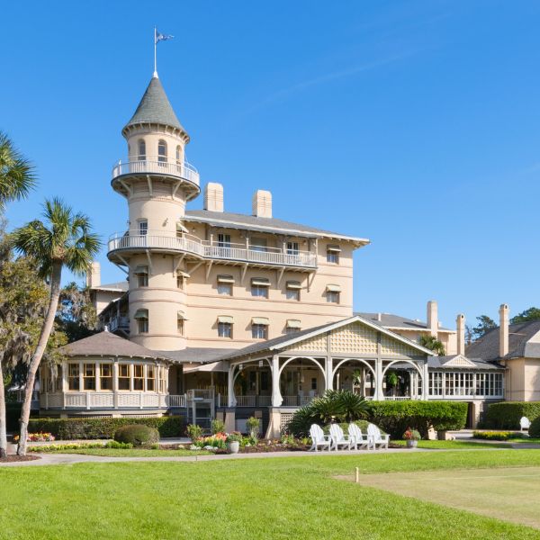 a large building with a lawn and a lawn with Jekyll Island in the background