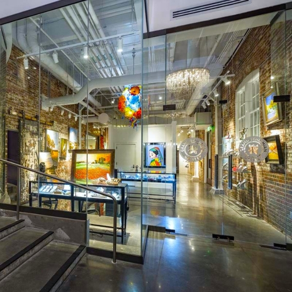 a glass wall with art and a staircase
