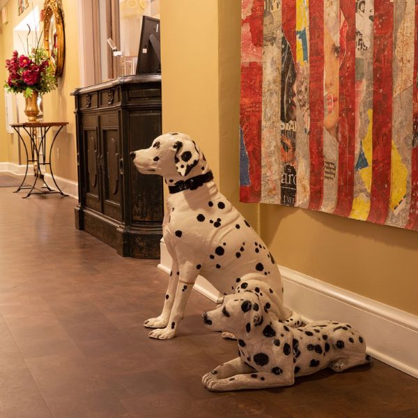 a stuffed dog sitting next to a wall