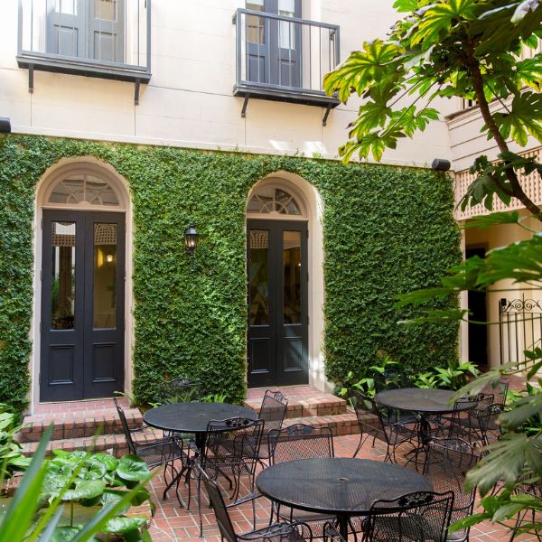 a patio area with tables and chairs outside of a building