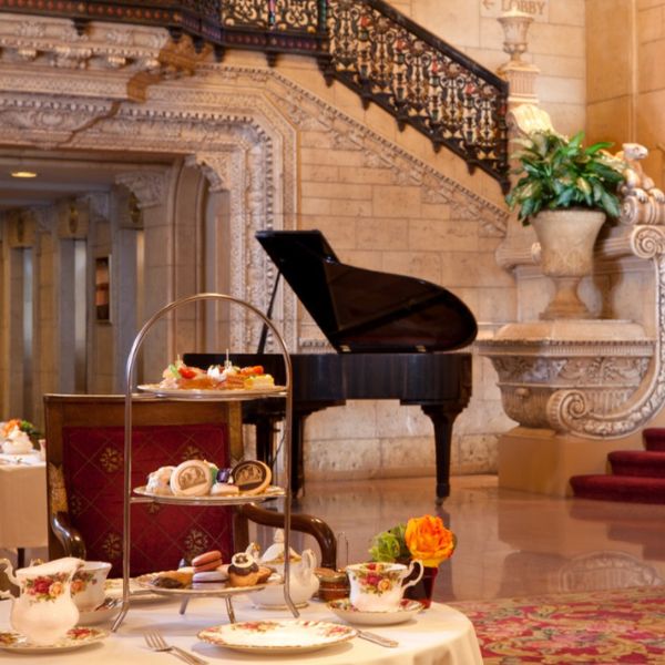 a tea party in a room with a grand piano