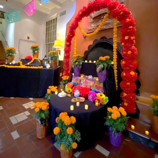 a room with a table with flowers and candles