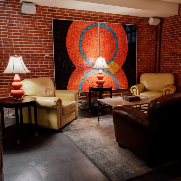 a room with a brick wall and a painting