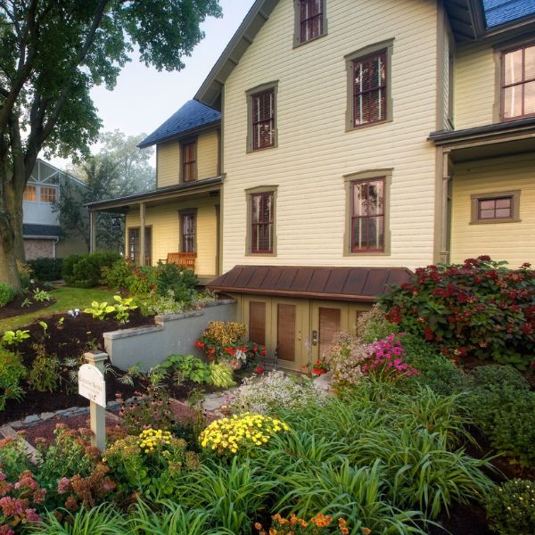 a house with a garden and a sign