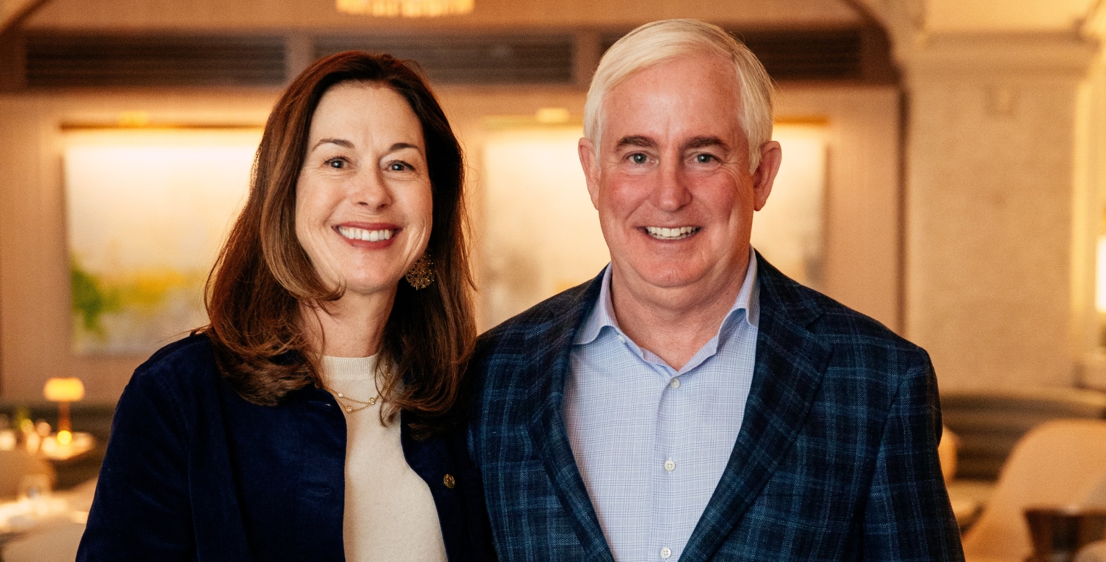 a man and woman smiling for a picture