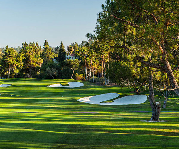 a golf course with sand bunkers