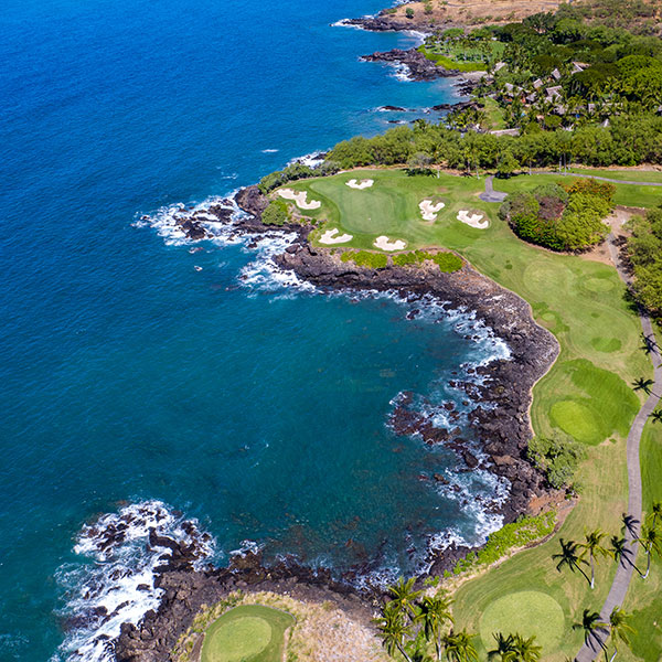 a golf course with a body of water