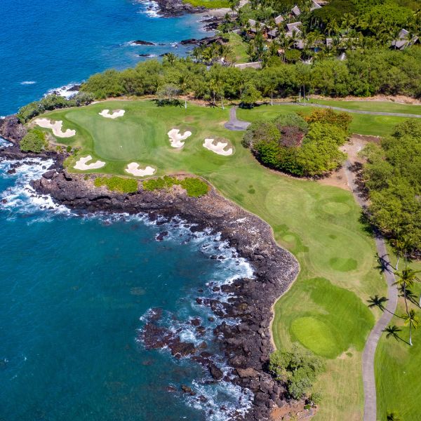 a golf course with a body of water