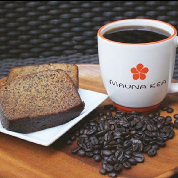 a plate of coffee and bread on a wooden tray
