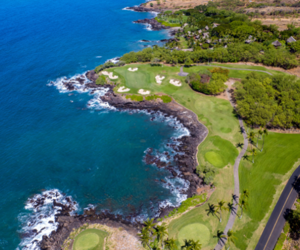 a golf course with a body of water