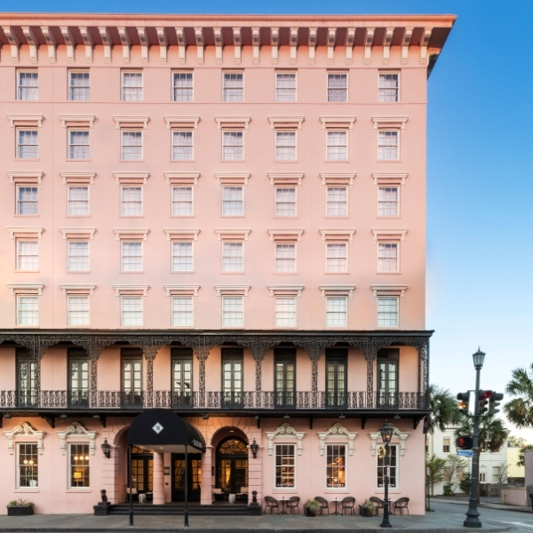 a pink building with black railings
