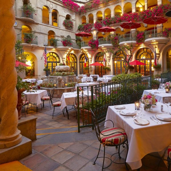 a courtyard with tables and chairs