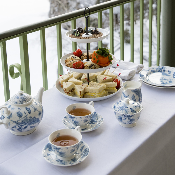 a table with tea cups and plates on it