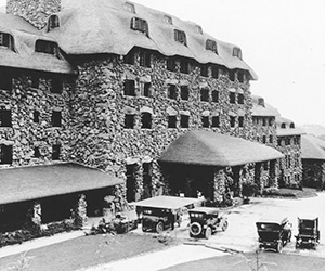 a stone building with cars parked outside
