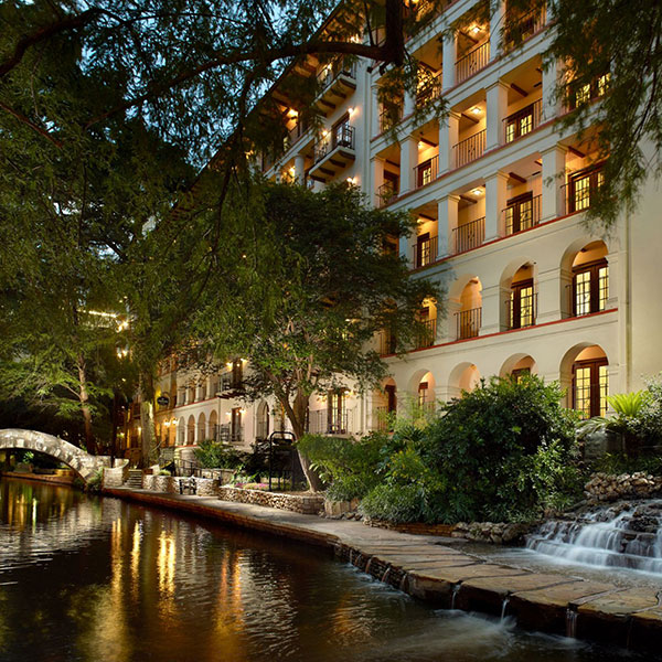 a building with trees and a river