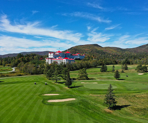 a large golf course with a large building in the background