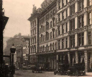 a black and white photo of a street with a building