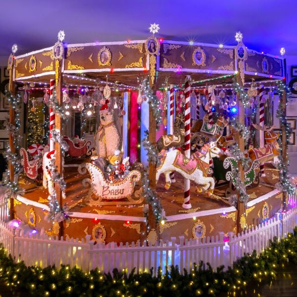 a gingerbread carousel with lights and garlands