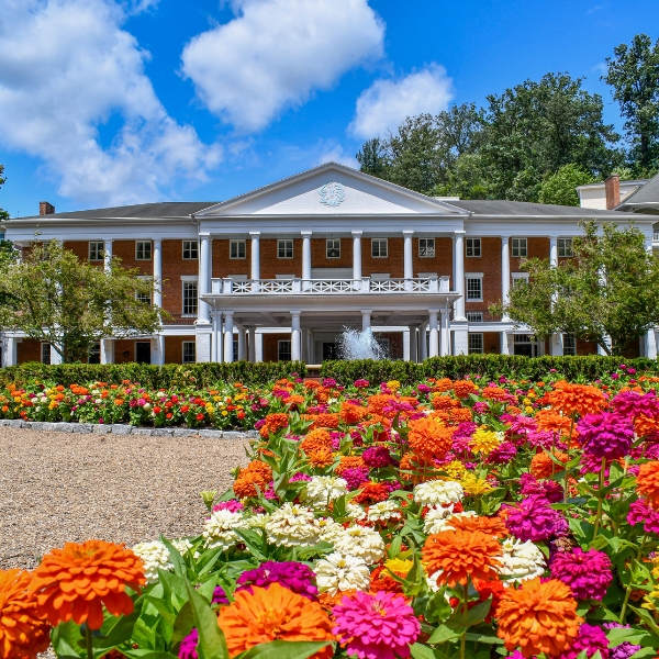 a large building with a garden of flowers