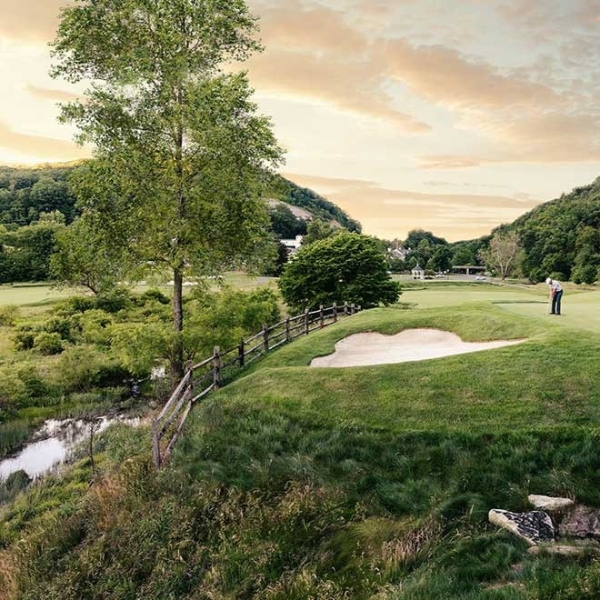 a man standing on a golf course