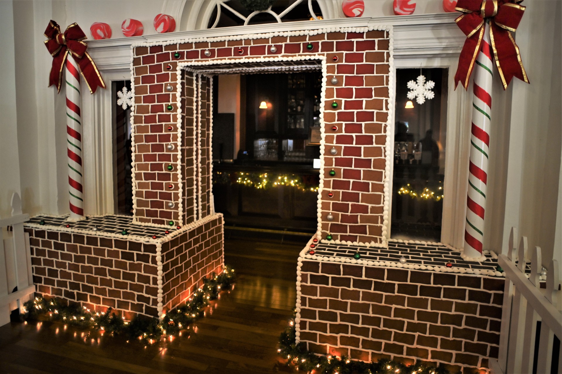 a brick archway with lights and decorations