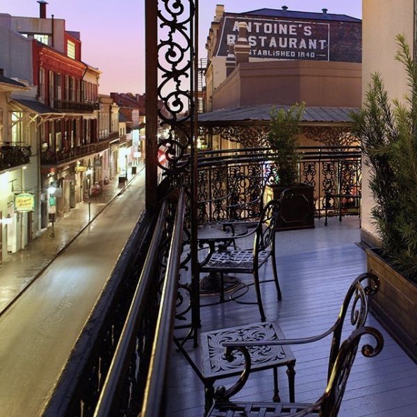 a balcony with chairs and tables on it