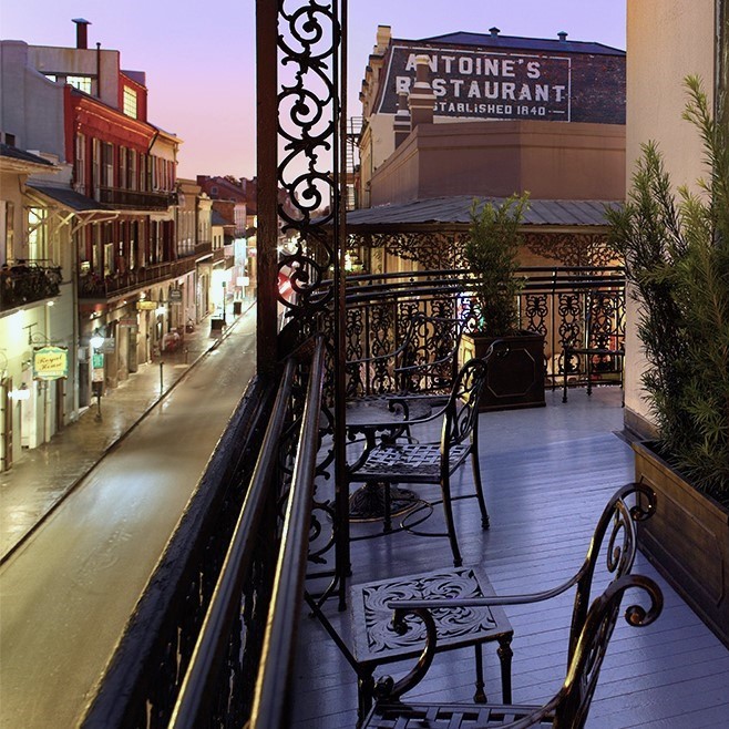 a balcony with chairs and a sign