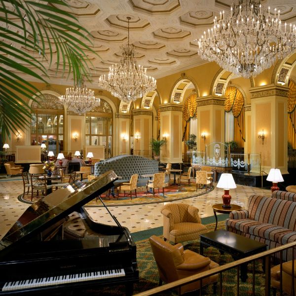 a room with chandeliers and piano