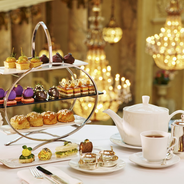 a tea set with a teapot and teapot and a tray of pastries