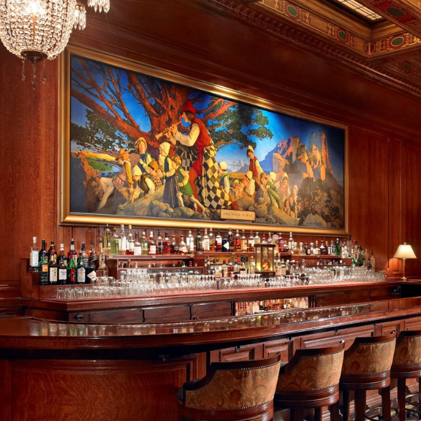 a bar with many bottles and glasses
