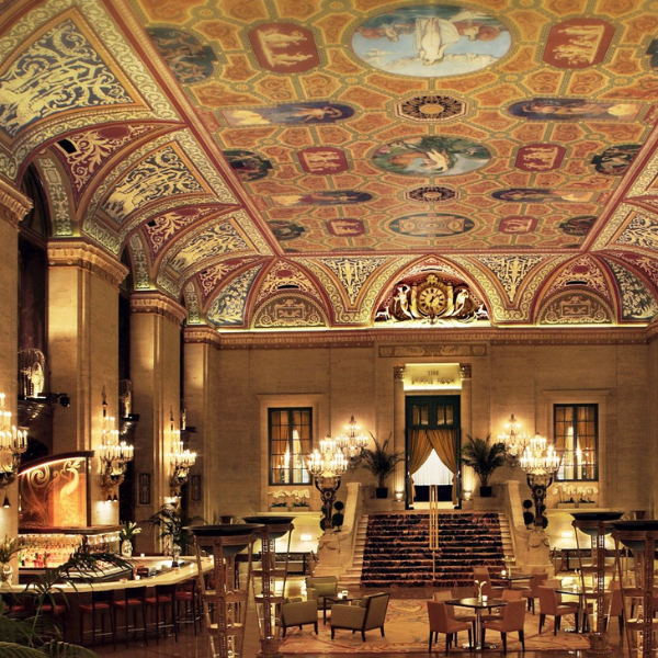 a large ornate room with a ceiling and chandeliers with The Palmer House Hilton in the background