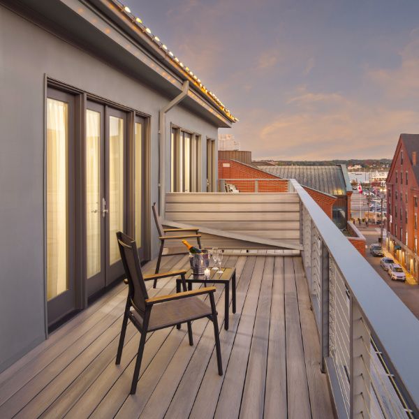 a balcony with chairs and tables on it