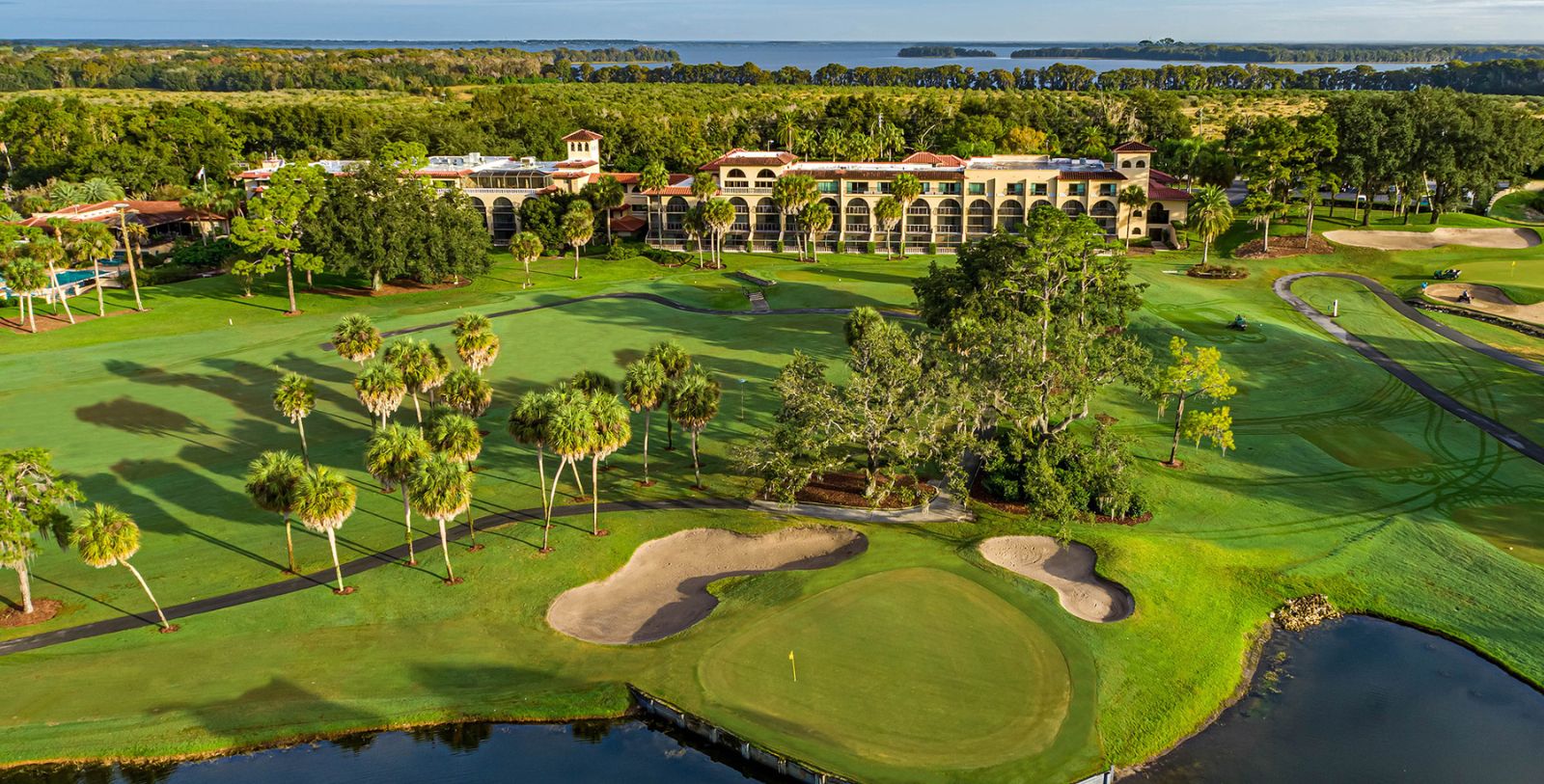 a golf course with a building and trees