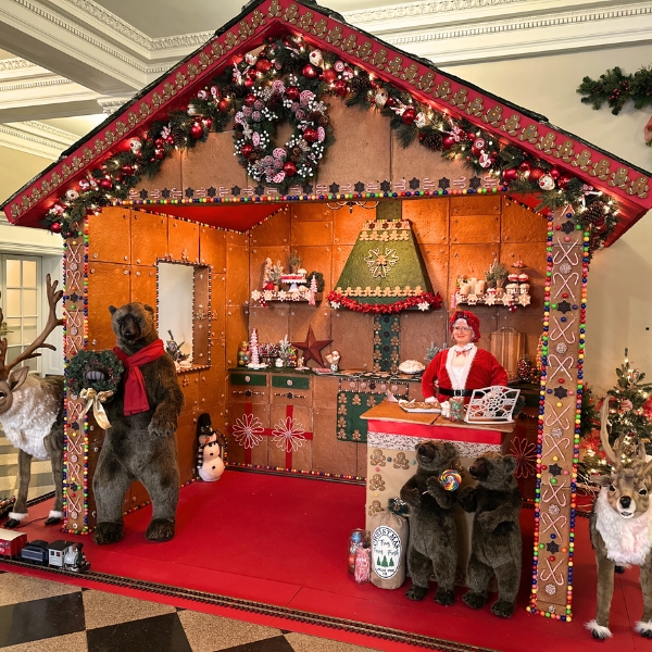 a gingerbread house with bears and reindeer
