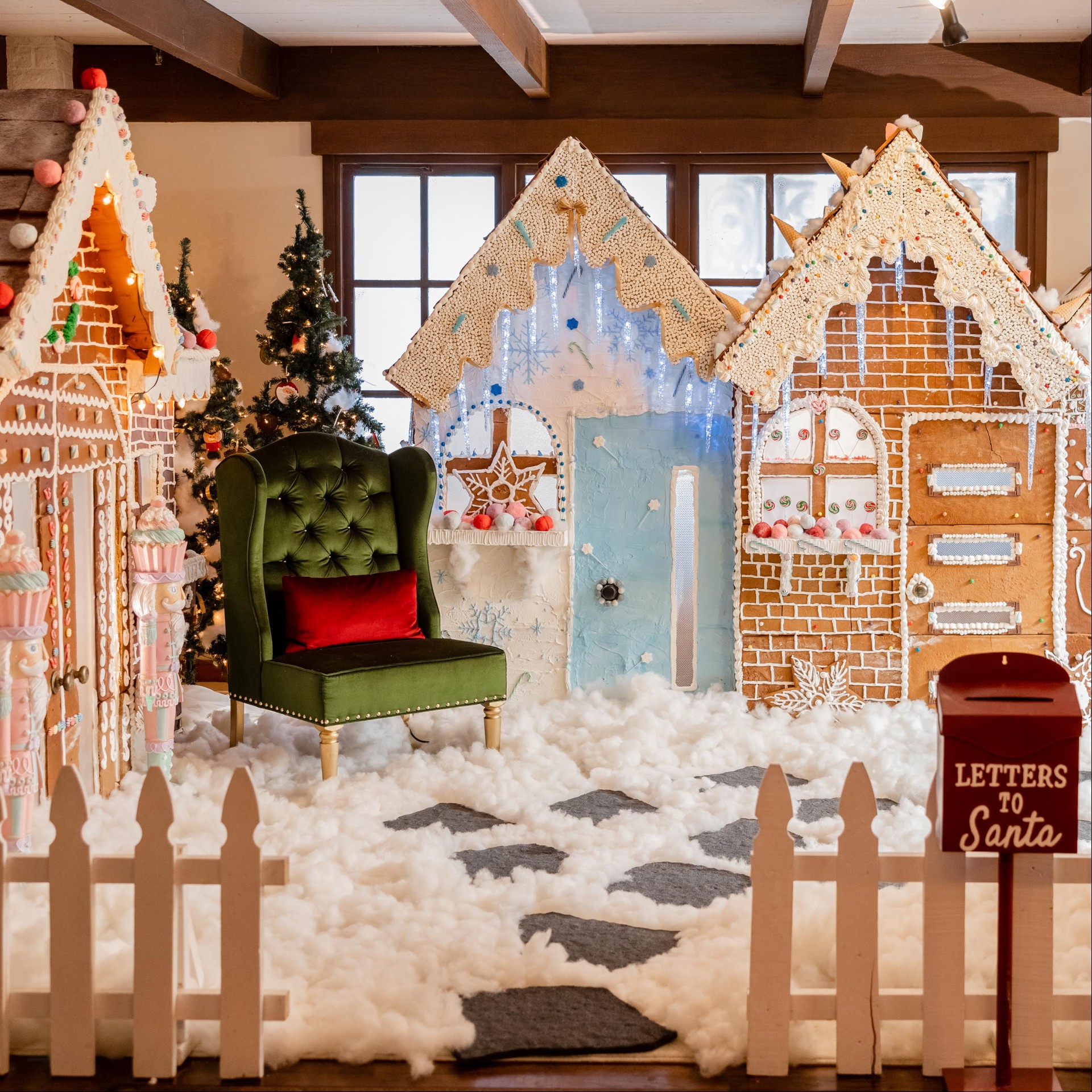 a room with a group of gingerbread houses and a chair