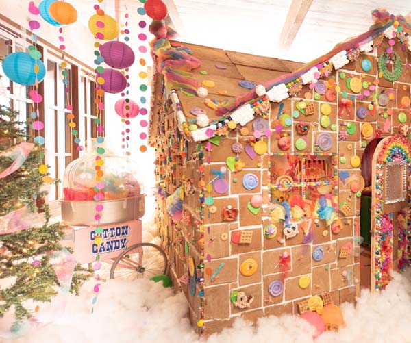 a gingerbread house with candy and a tree