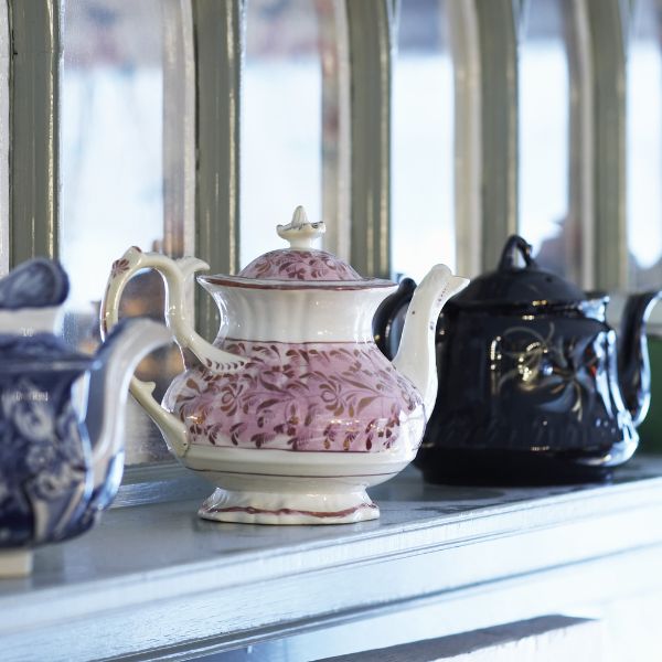 a group of teapots on a shelf