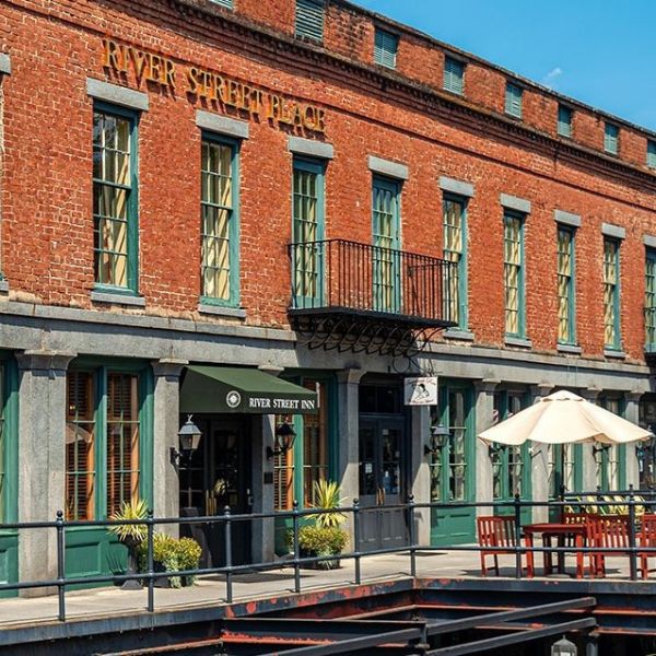 a brick building with a river in the background