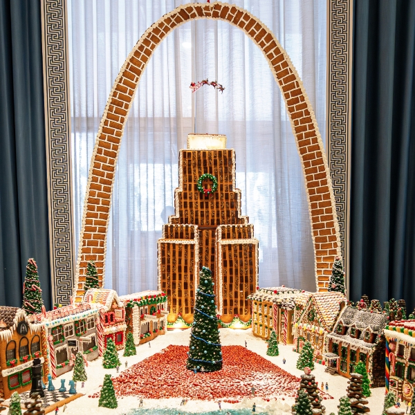 a gingerbread city with trees and a christmas tree